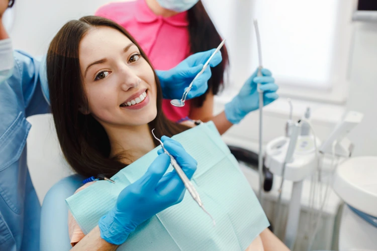 Female patient smiling and showing her perfect white teeth before undergoing dental procedure.