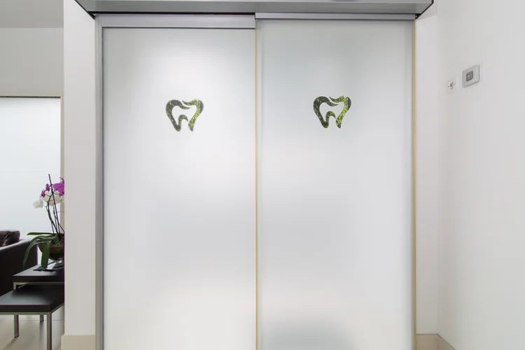 Calming dental clinic entrance with clean, modern design to help ease dental anxiety in Singapore.