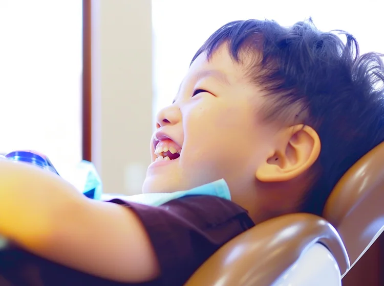 Cheerful and relaxed Singaporean child with special needs at the dental clinic for his regular dental check-up.
