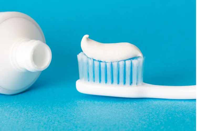 Close-up of desensitising toothpaste and a toothbrush to help reduce sensitivity and discomfort caused by LED teeth whitening.