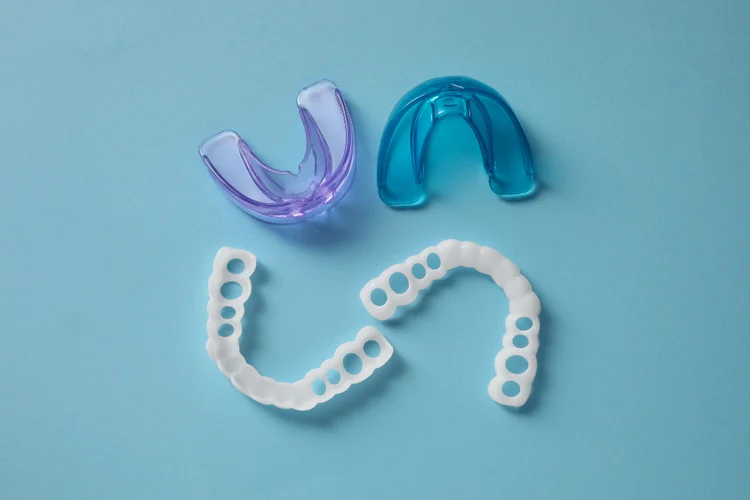 Custom and stock mouth guards used for teeth protection in sports and bruxism prevention.