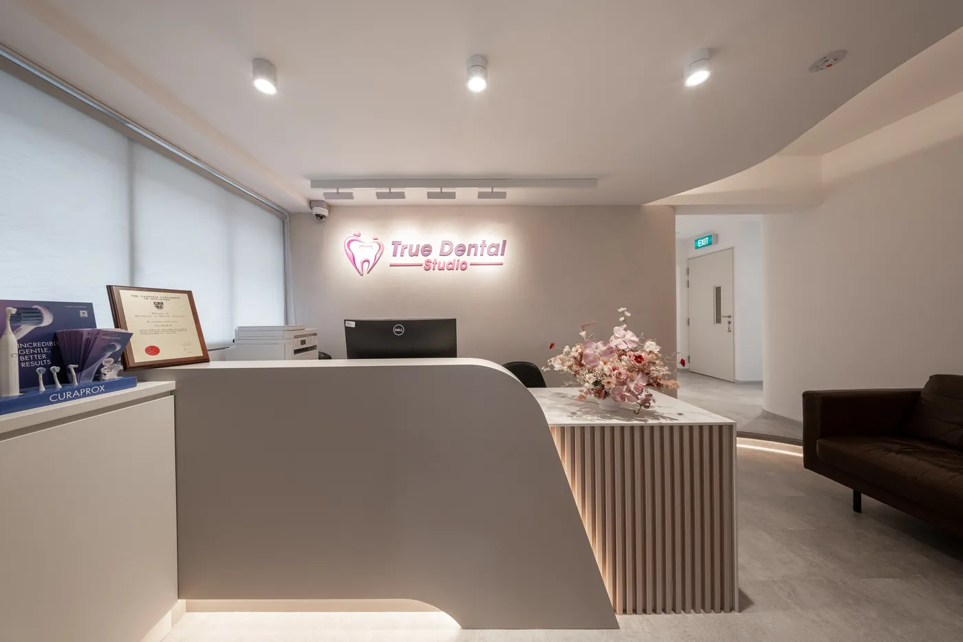 Reception desk with the True Dental Studio sign at our dental clinic in Ang Mo Kio.