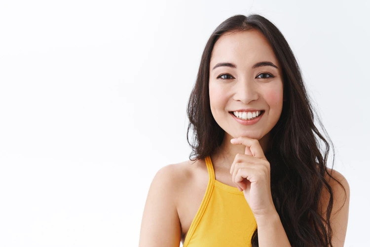 Confident-looking lady with nice skin complexion flashing a wide smile and showing her nice and white teeth.