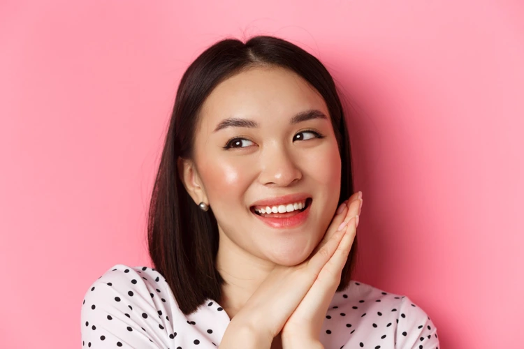 Lady smiling and feeling happy through confidence gained from healthy skin complexion.