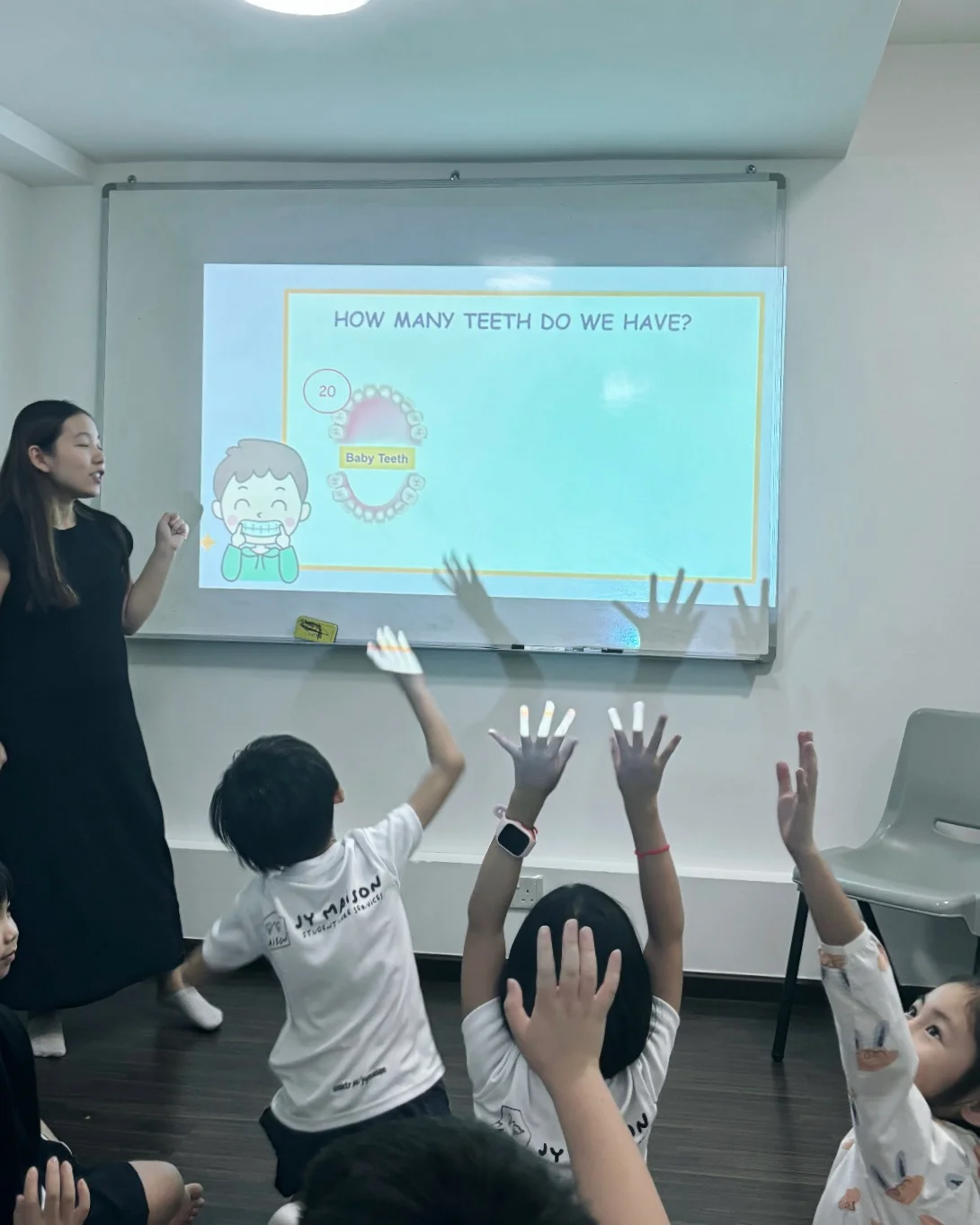 Kalinda Teo teaching a group of children about oral health.