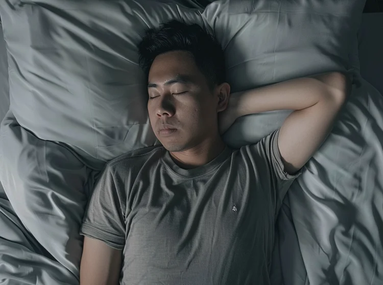 Singaporean man experiencing poor sleep quality due to increased snoring and bruxism caused by an underbite.