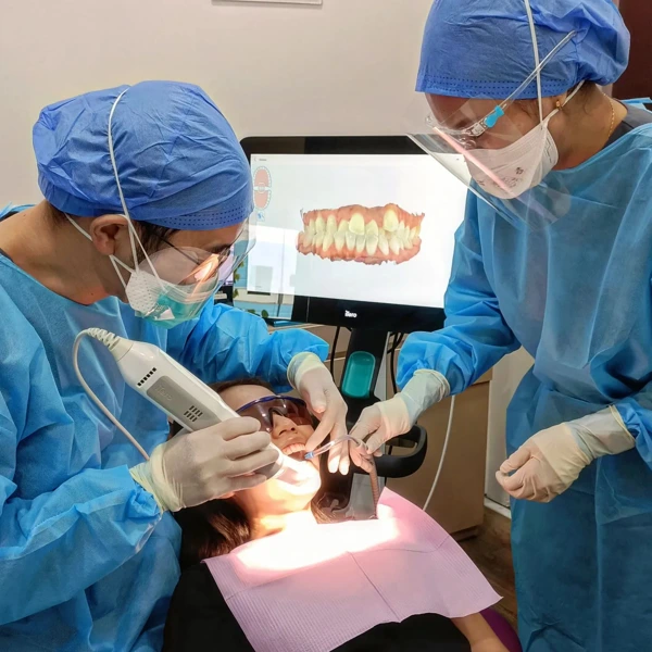 Female patient undergoing dental procedure at True Dental Studio.