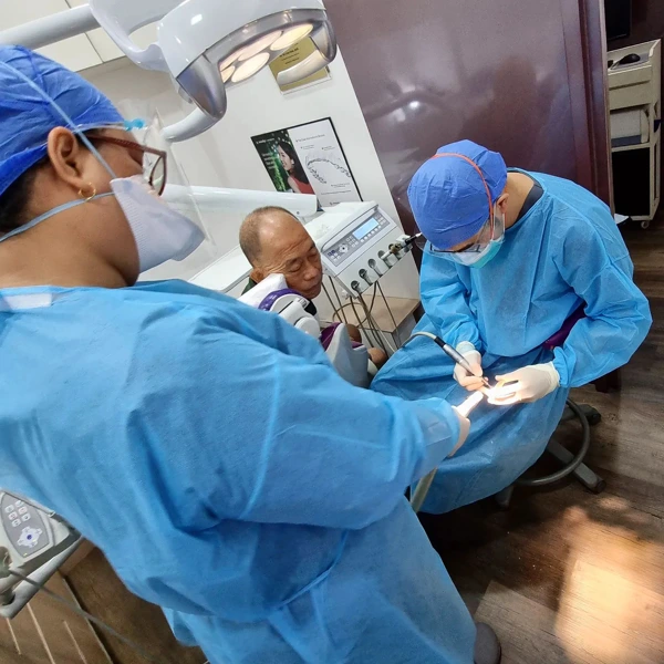 Elderly male patient undergoing dental procedure at True Dental Studio.