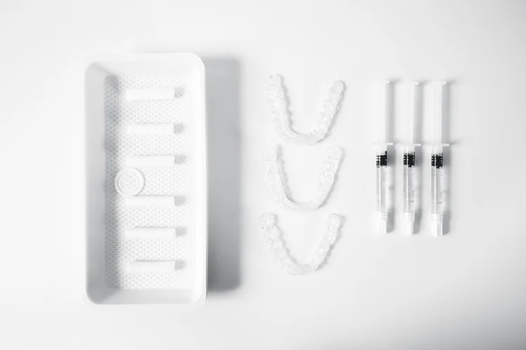 Teeth whitening kit prescribed by the dentist, containing customised trays and professional-grade whitening gel.